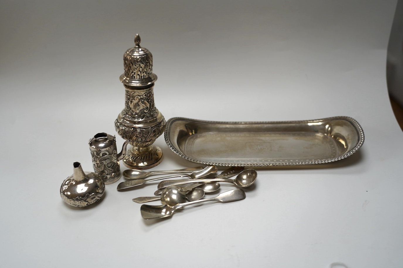 A George III silver snuffers stand, London, 1810, 22.8cm, together with sundry silver flatware, a silver sugar caster, a miniature Chinese white metal tea kettle by Wang Hing, lacking cover and one other item. Condition